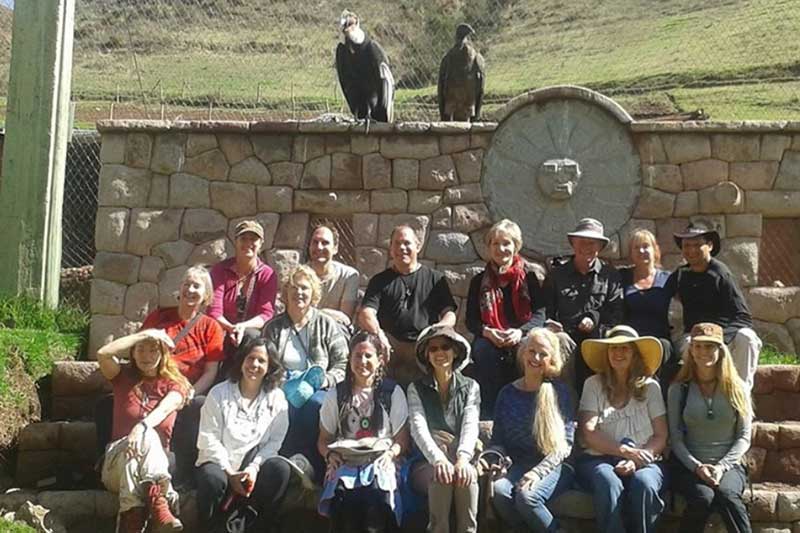 Group of visitors at Wildlife Cusco with eagles in the background