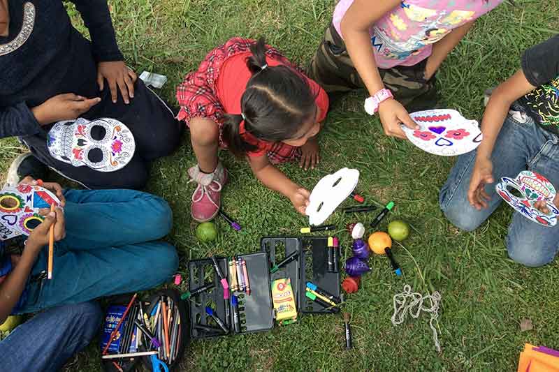 Children doing handicrafts outdoors from Mexico